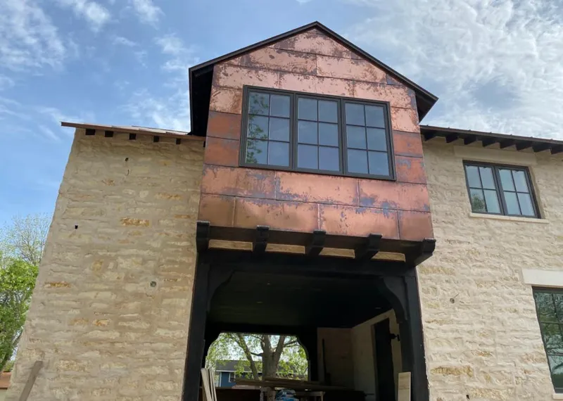 Copper metal panel facade on a stone building for Metal Roof Coating in Willis