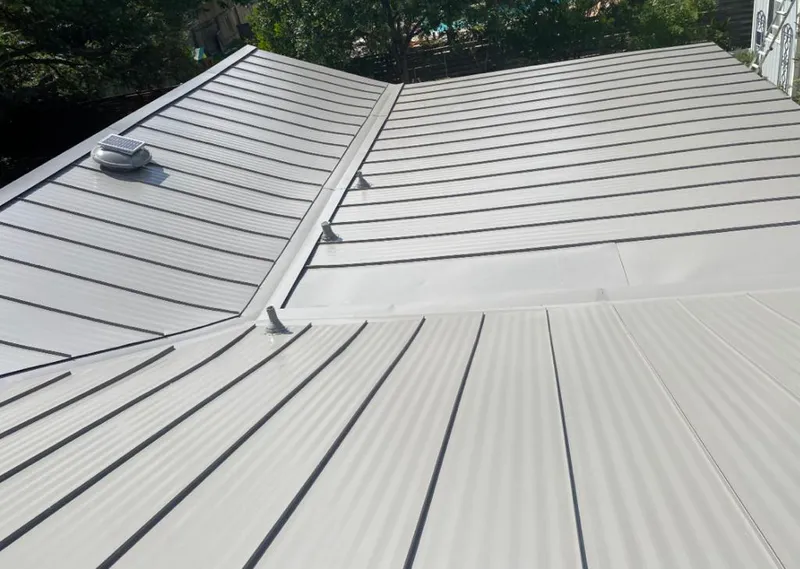 Solar attic fan installed on a metal roof for Roof Ventilation in Willis